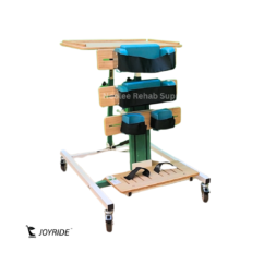 Front angled view of the Joyride Prone Standing Frame featuring padded chest, waist, and calf supports, adjustable activity tray, foot platform, and caster wheels.