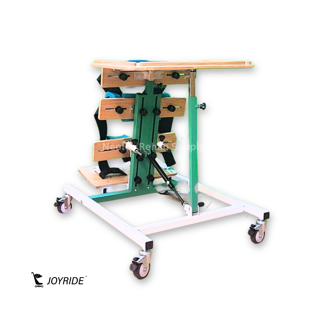 Side angled view of the Joyride Prone Standing Frame displaying adjustable support brackets, standing platform, padded positioning supports, and lockable caster frame.