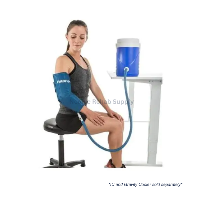 Woman using Aircast elbow cryo cuff connected to portable cooling unit for rehabilitation and post-injury recovery therapy.