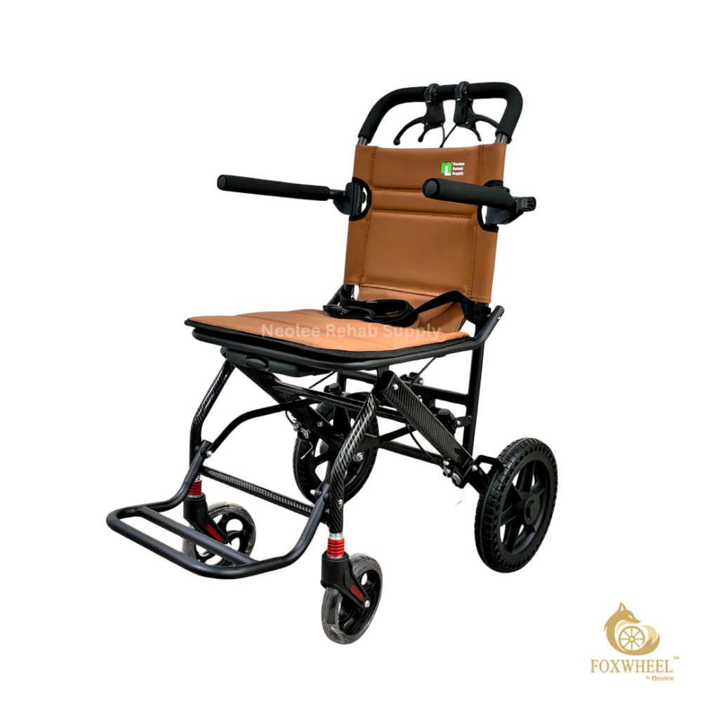 A front three-quarter product view of the Foxwheel travel wheelchair showcasing its tan padded seat, compact foldable frame, black wheels, footrest, and ergonomic travel design.
