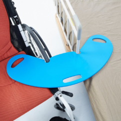 Neo Wing transfer board positioned between a wheelchair and hospital bed to assist safe and smooth patient lateral transfers.